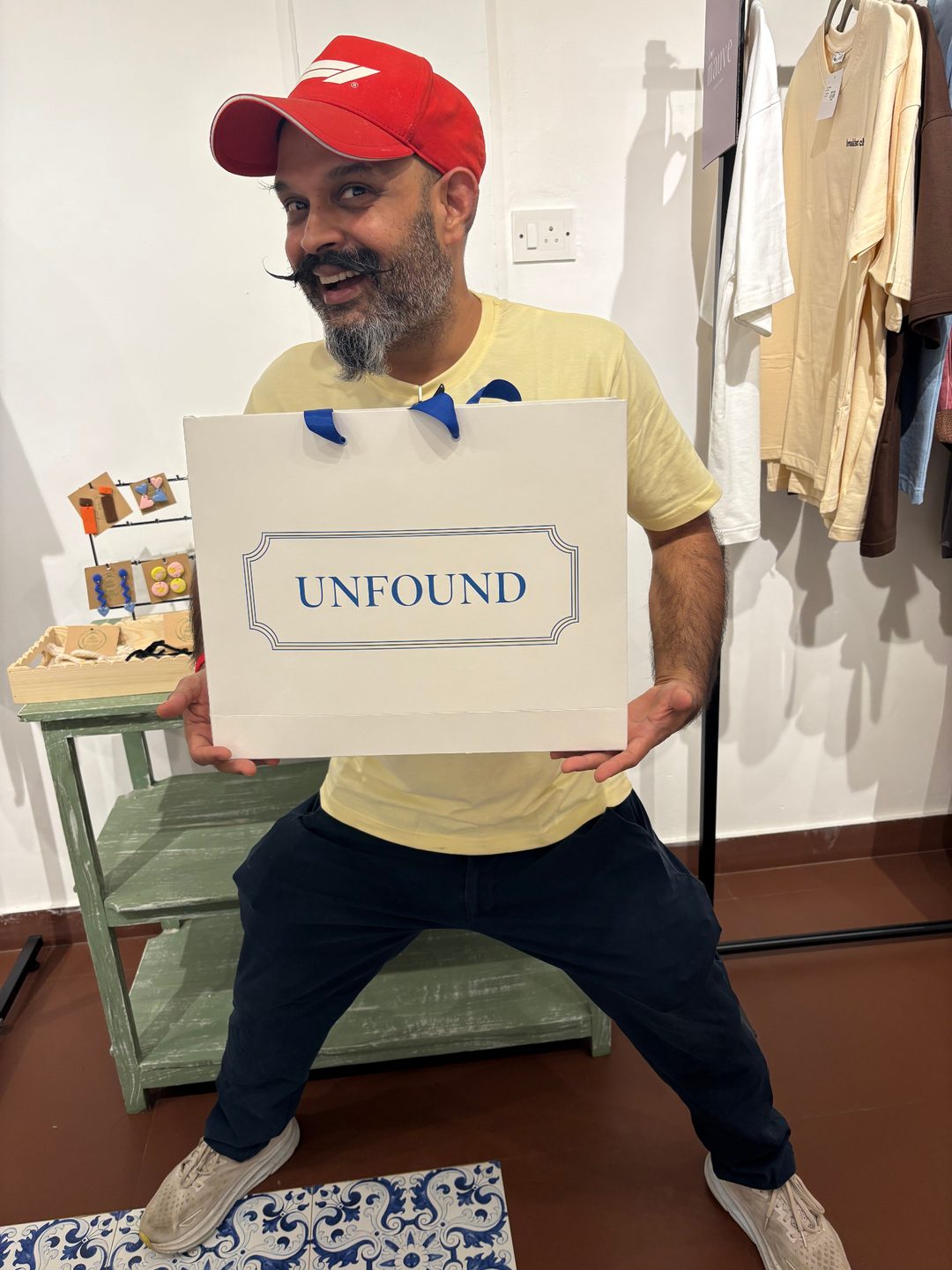 Happy customer leaving with an Unfound bag